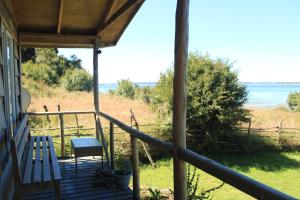 a porch of a house with a view of the ocean at Cabaña en Caulin 1 in Ancud