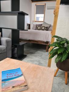 ein Schlafzimmer mit einem Bett und einem Buch auf einem Tisch in der Unterkunft Backyard Nook in South West Rocks