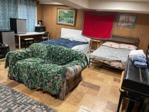 a room with a bed and a couch and a chair at Flower Avenue Hosting - Private Suite with De Luxe King Size Bed - 77 per Night 1st guest - 59 2nd guest - 52 each third & 4th guests in Silver Spring