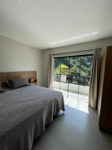 a bedroom with a bed and a large window at Castel Luz in Angelina +66 photos