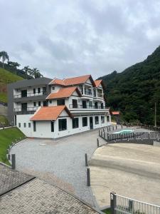 a large white building with a fence in front of it at Castel Luz in Angelina