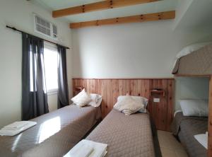 a room with two beds and a window at Dormis H35 in Ataliva Roca
