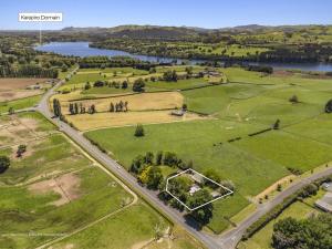 an aerial view of a park with a lake at Sanctuary Cottage in Karapiro