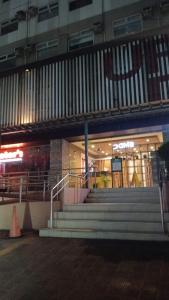 a store with stairs in front of a building at Nicecondotel in Manila