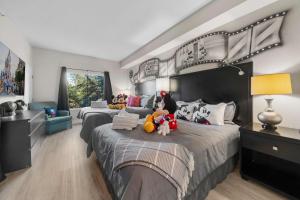 a bedroom with two beds with stuffed animals on them at Pool View DisneyUniversalFree ShuttleParking in Orlando +47 photos