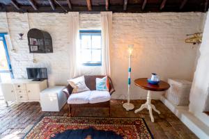 a living room with a chair and a table at The Globe Inn in Yass