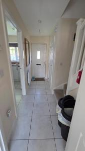 a hallway of a bathroom with a tile floor at Wishart Drive in Curborough +13 photos