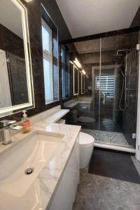 a bathroom with a tub and a toilet and a shower at Private Suite in a Friendly Shared Home in Vancouver