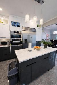 a kitchen with a counter with a plate of fruit on it at Private Suite in a Friendly Shared Home in Vancouver