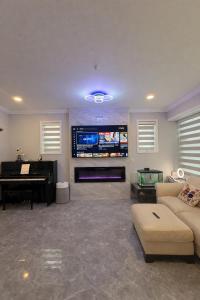 a living room with a couch and a piano at Private Suite in a Friendly Shared Home in Vancouver