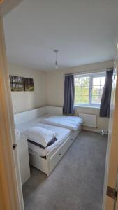 a bedroom with two beds and a window at Wishart Drive in Curborough