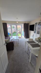 a living room with a couch and a table at Wishart Drive in Curborough