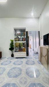 a refrigerator in a room with a tiled floor at BS myhome in Sathani Hat Yai