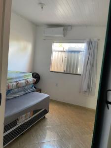 a small room with a bed and a window at Casa com Piscina em Prado Bahia in Prado +23 photos