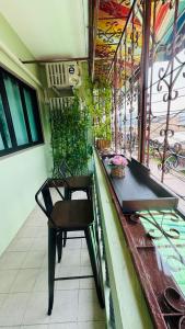 a chair sitting at a bar on a balcony at BS myhome in Sathani Hat Yai