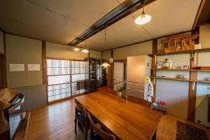 a kitchen with a wooden table in a room at Kominka engawa in Kakamigahara