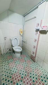 a bathroom with a toilet and a tiled floor at BS myhome in Sathani Hat Yai +37 photos