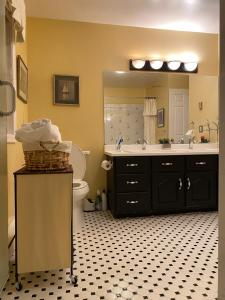 a bathroom with a sink and a toilet and a mirror at Downtown Halifax suites in Halifax +22 photos
