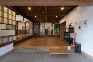 a large room with a wooden floor and a bench at 多古の里 l 300平米超の古民家を一棟贅沢貸切 l BBQ ドッグラン in Tako