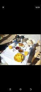 a table with plates of food on top of it at Kasbah des roses in Aït Saïd
