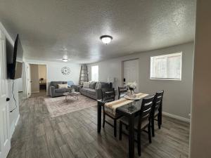 a living room with a table and chairs and a couch at Cozy Apt in Downtown Logan in Logan