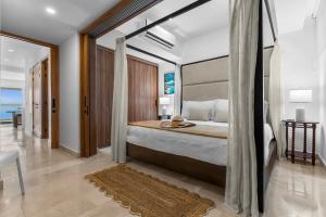 a bedroom with a large bed with a large window at Casa Corazon at Harbor 171 North Tower in Puerto Vallarta