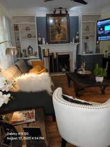 a living room with a couch and a fireplace at Southern Charmer in Stone Mountain
