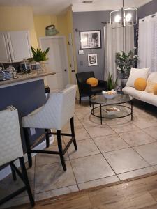 a living room with a couch and a table at Southern Charmer in Stone Mountain