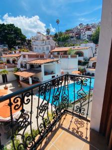 a balcony with a view of a swimming pool at Casa Adobe Balcony Breathtaking Cathedral Views in Taxco de Alarcón