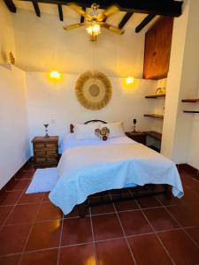 a bedroom with a bed and a ceiling at Casa Adobe Balcony Breathtaking Cathedral Views in Taxco de Alarcón +79 photos