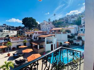 a view from the balcony of a building with a swimming pool at Casa Adobe Balcony Breathtaking Cathedral Views in Taxco de Alarcón