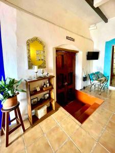 a living room with a table and a mirror at Casa Adobe Balcony Breathtaking Cathedral Views in Taxco de Alarcón