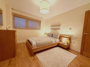 a bedroom with a bed and a window at Cardiff City Center - FREE On-Site Parking in Cardiff