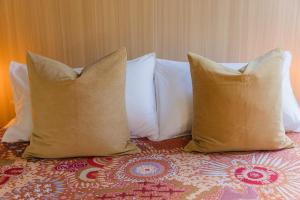 a group of pillows sitting on top of a bed at Dreamseed Cabin by Tiny Away in Yandina