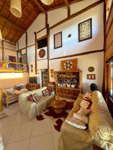 a large living room with two couches in a room at Mirantes Paraibuna - Casa Vermelha in Paraibuna