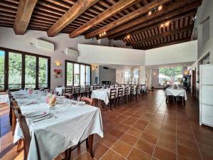 a dining room with white tables and chairs at La Noce di Creta in Poggio Moiano
