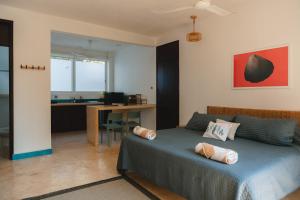 a bedroom with a bed and a desk with a computer at Maralagua in Puerto Escondido
