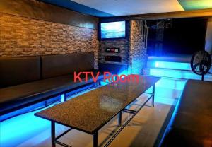 a table in a bar with a kyr reborn sign at McHanns Place in Antipolo