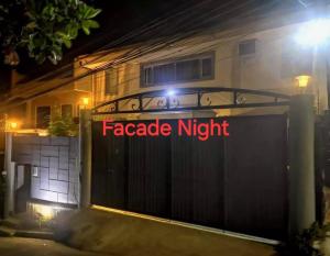 a gate with aagnetic night sign in front of a house at McHanns Place in Antipolo