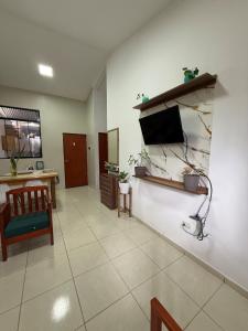 a living room with a flat screen tv on a wall at Casa Jardín Relax in Moyobamba