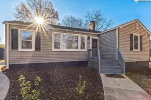a small house with a staircase in a yard at Sweet Home in Greenville