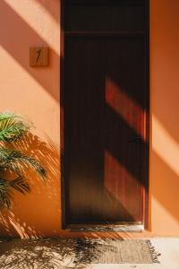a black door on the side of a building at Maralagua in Puerto Escondido +30 photos