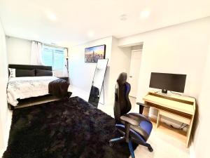 a bedroom with a bed and a desk and a chair at Prime DMV Stay in Silver Spring
