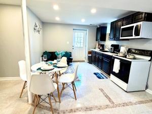 a kitchen with a table and chairs in a room at Prime DMV Stay in Silver Spring
