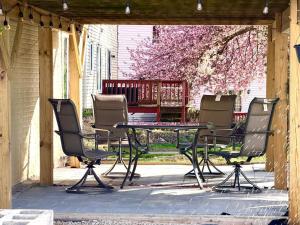 a patio with a table and chairs and a bench at Prime DMV Stay in Silver Spring