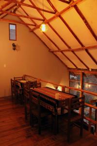 a dining room with tables and chairs in a room at Terra Alta Lodge in Yanque