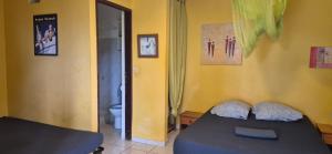 a bedroom with a bed with two pillows on it at LEFOUXIOL in La Trinité