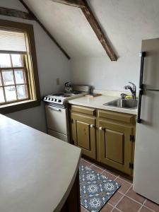 a kitchen with a sink and a refrigerator at Historic Block Island Suite in New Shoreham +12 photos