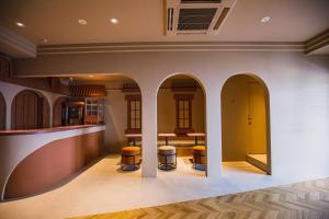 a room with a bar with stools and a table at SABLIER by R HOTEL in Osaka