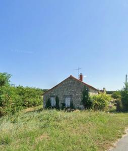 an old stone house on the side of a road at Le bois saint Hilaire in Lémeré